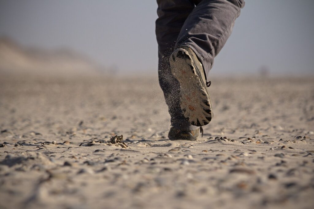 Silhouette of a person walking with a step tracker, symbolizing 20,000 steps, equivalent to a 10-mile distance.