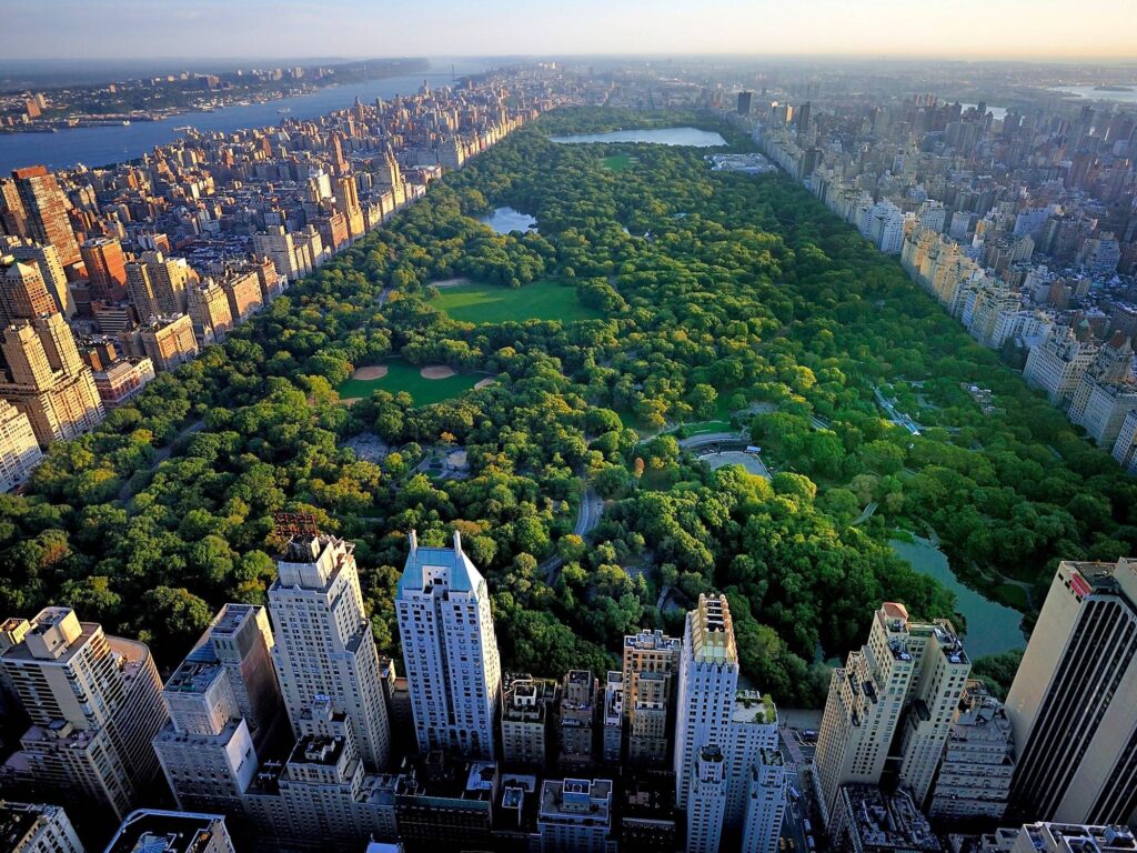 Aerial view of Central Park’s main loop, showcasing landmarks like Belvedere Castle, representing a 10-mile journey around the park